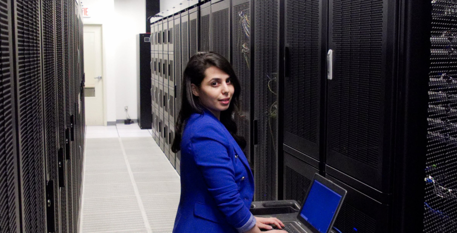  Person standing in aisle between Colocation Cabinets